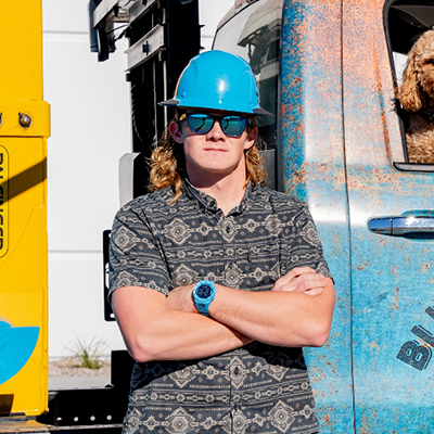 photo of man in a hard hat in front of a truck