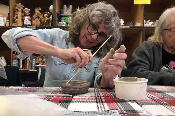 adults creating hand-built pottery