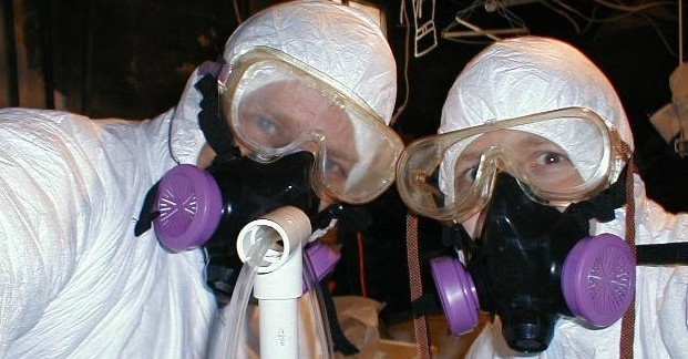 Two men wearing eye covers and oxgygen masks.
