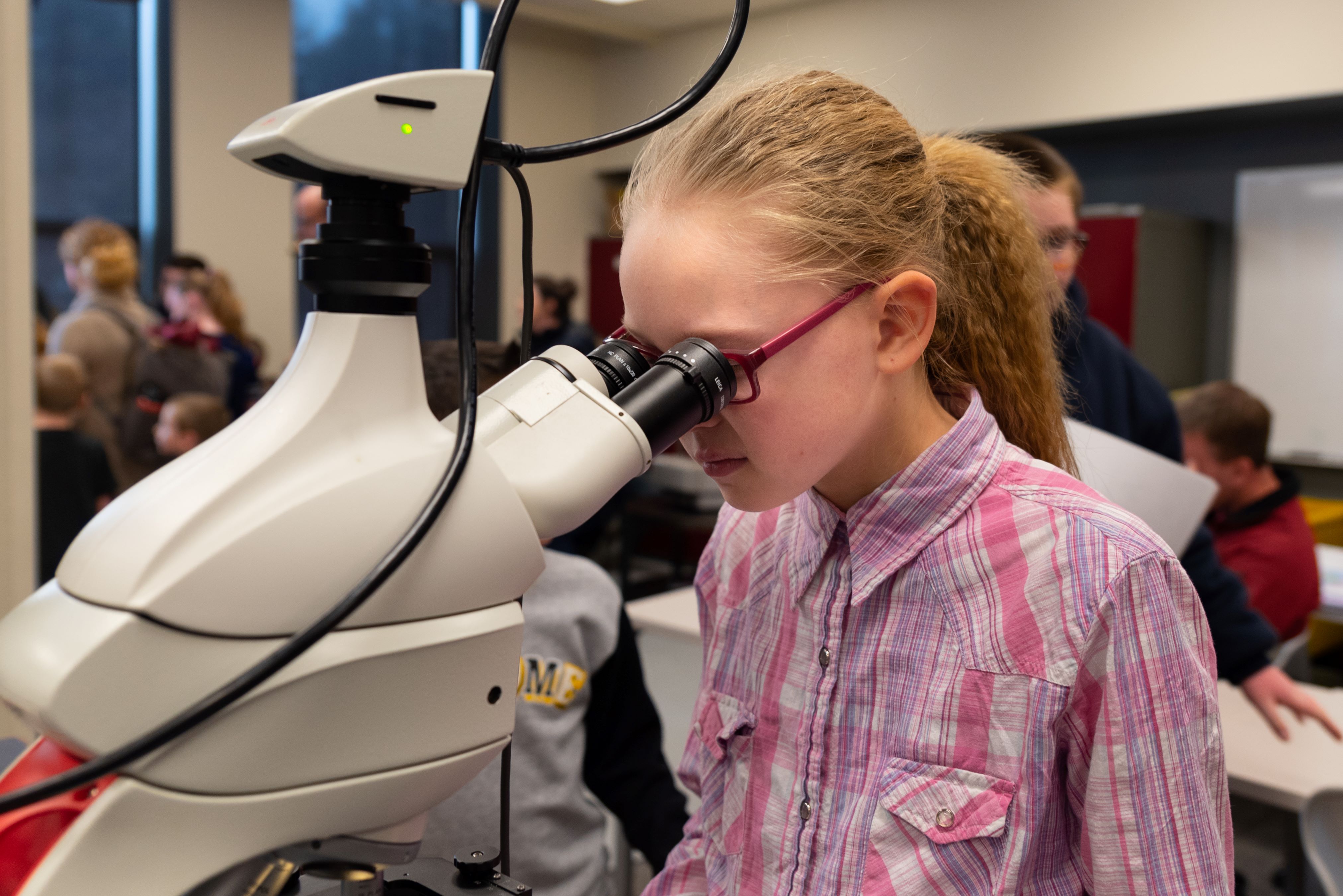 girl looking in microscope