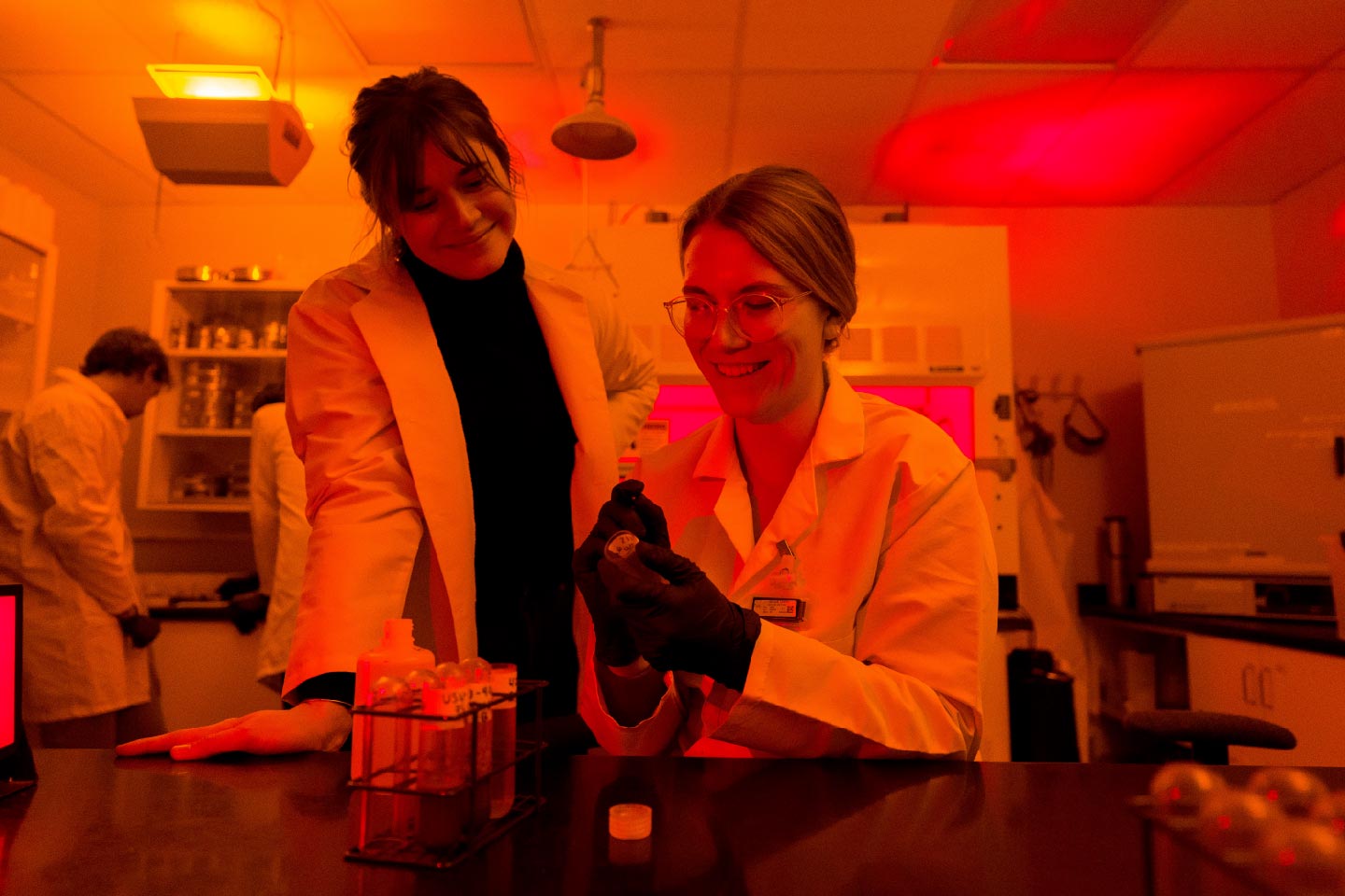 Two students using high density liquid for heavy mineral separation