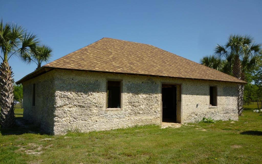 a rock home with a shingled roof
