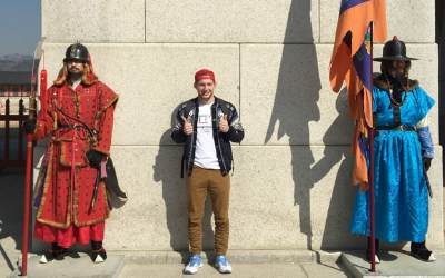 USU Alumnus Russell Anderson poses with 2 Korean men dressed in ancient warrior attire 