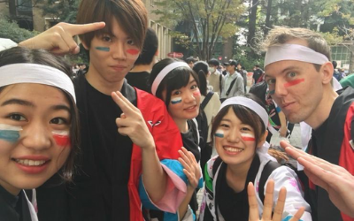 USU Alumnus Colter Christensen poses with some Japanese students