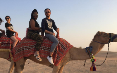 students riding a camel