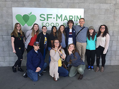 happy student group in front of SF Marin Food Bank sign