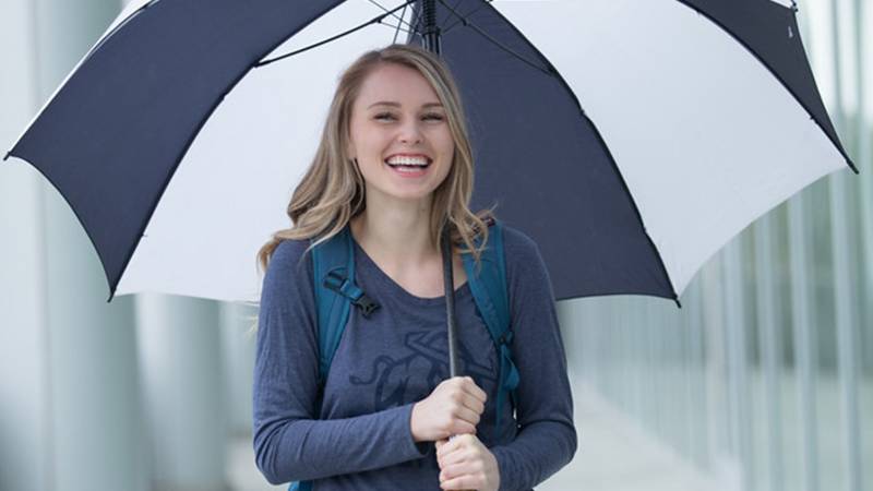 student holding umbrella