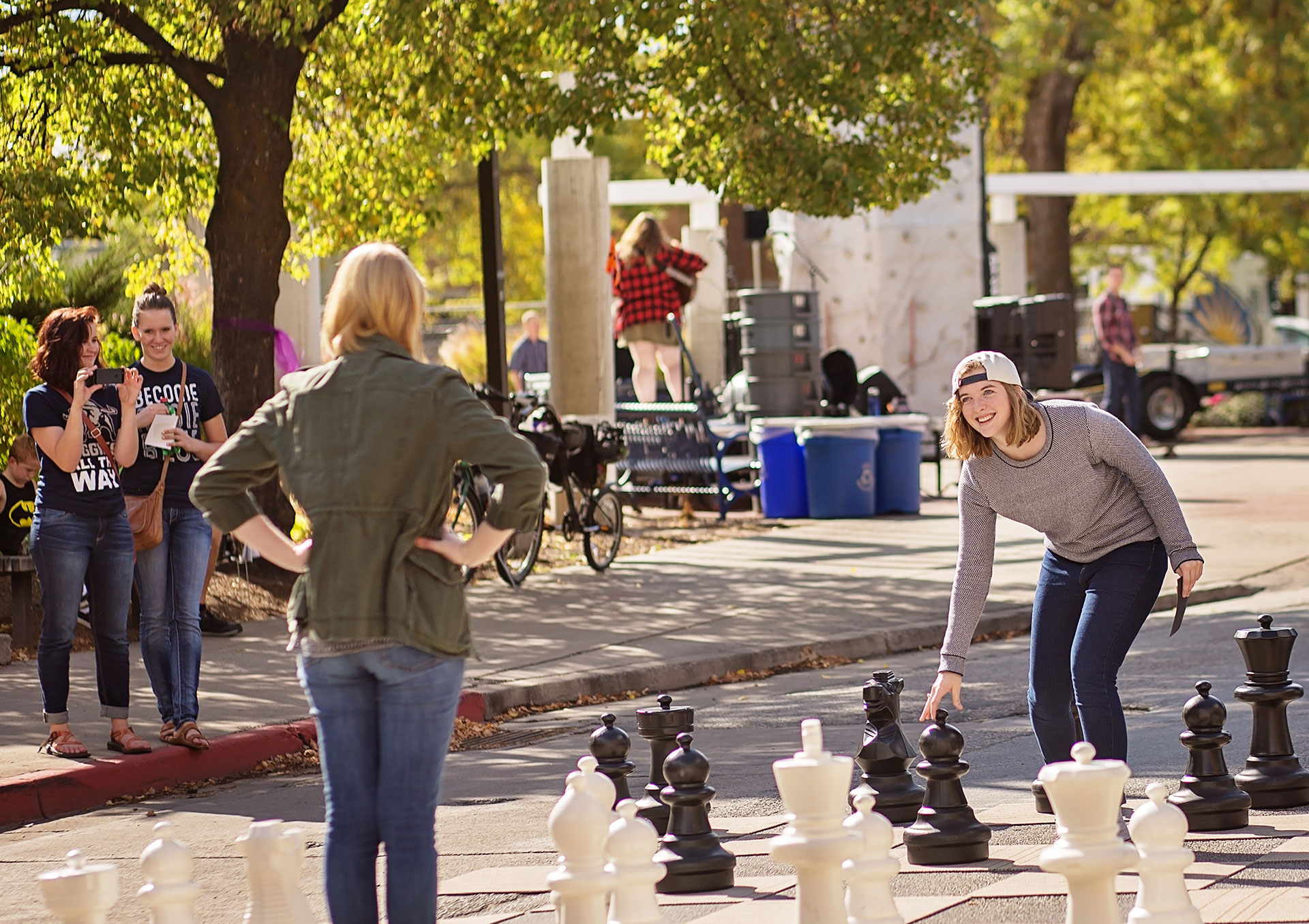 students playing large chess on campus