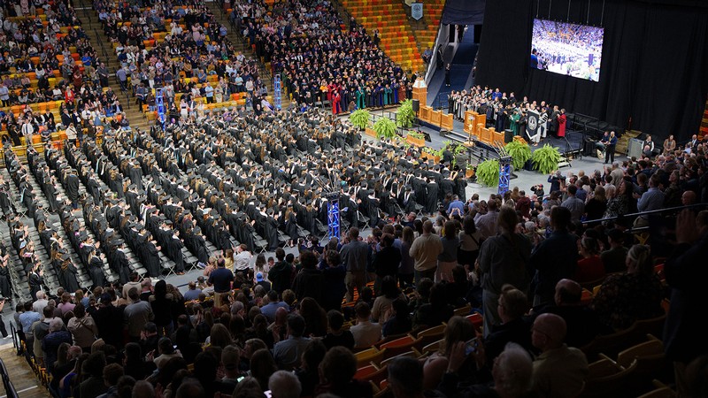 Bird's eye view of USU's Spectrum filled with students for commencement