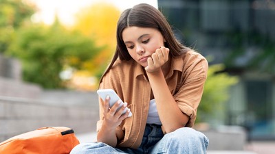 A person looking at a cell phone.