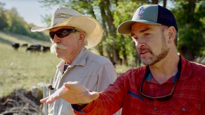 People speaking on a ranch.