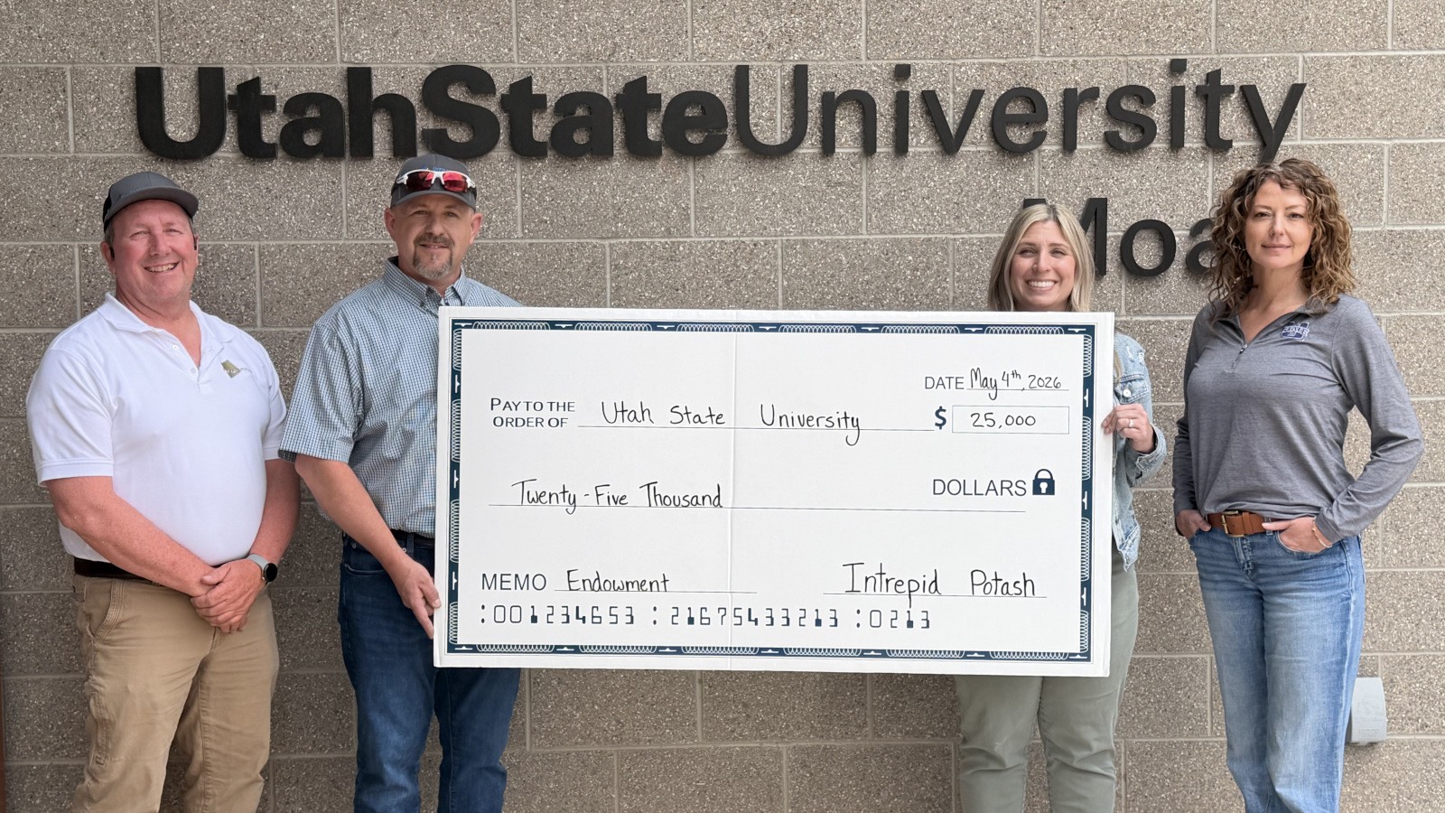 People holding a giant check for $25,000 from Intrepid Potash to USU.