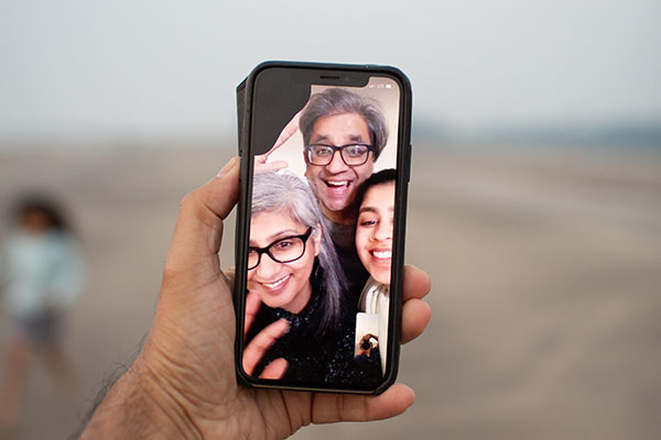 cell phone with smiling faces on screen