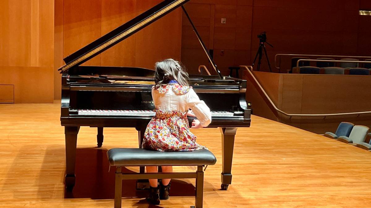 student playing piano at recital